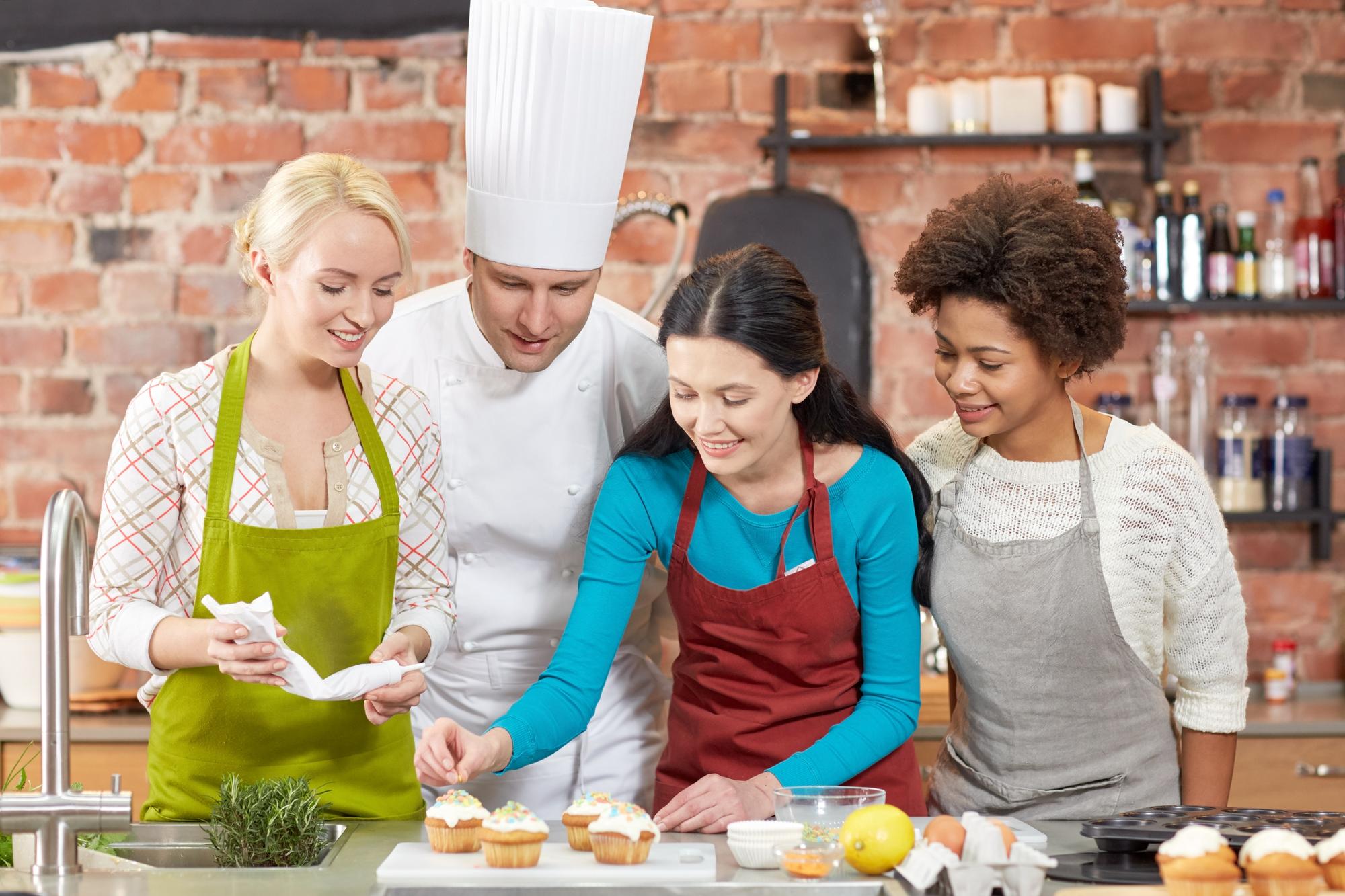 Small class of students around a cooking island